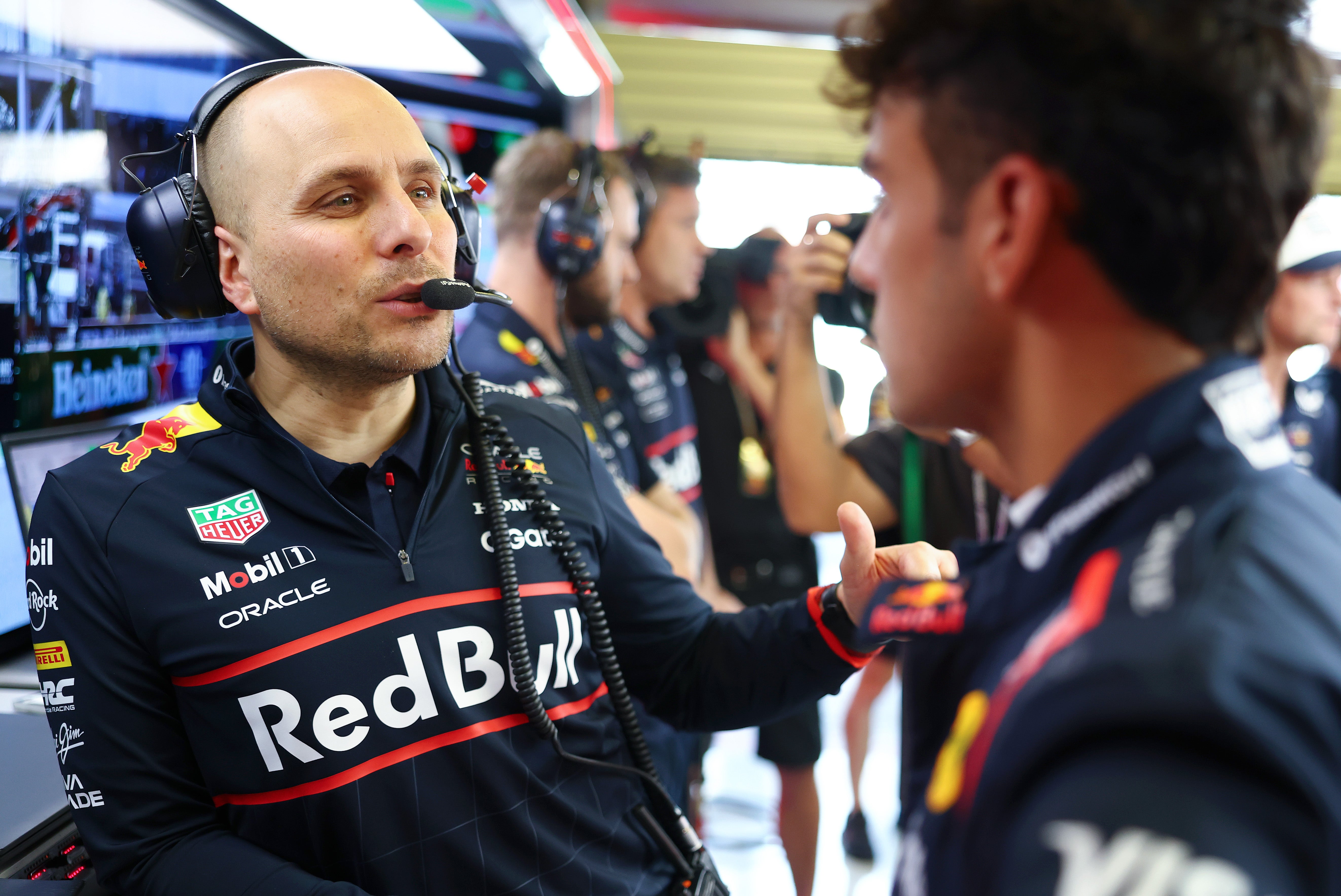 Lindblad speaks to Max Verstappen's race engineer Gianpiero Lambiase (left)