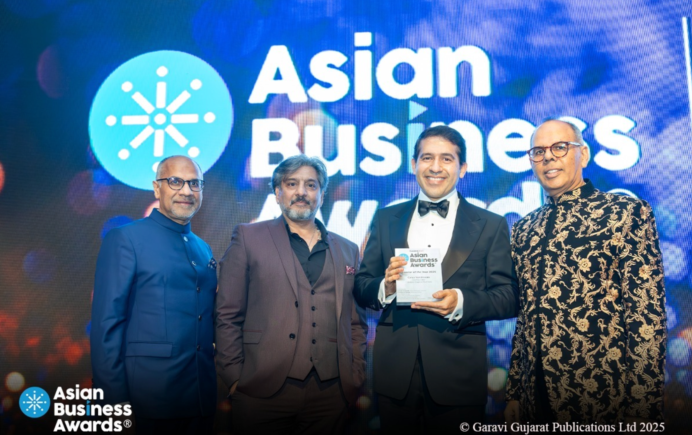 Cyrus Vandrevala (third from left), winner of Asian Business Awards Investor of the Year, announces donation to The Independent’s SafeCall campaign