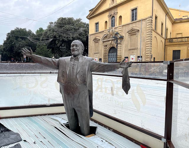 <p>The statue of Pavarotti in the town of Pesaro is now surrounded by an ice rink</p>