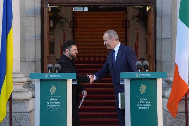 Ukrainian President Volodymyr Zelensky and Taoiseach Micheal Martin shake hands during a press conference at Government Buildings in Dublin (PA)