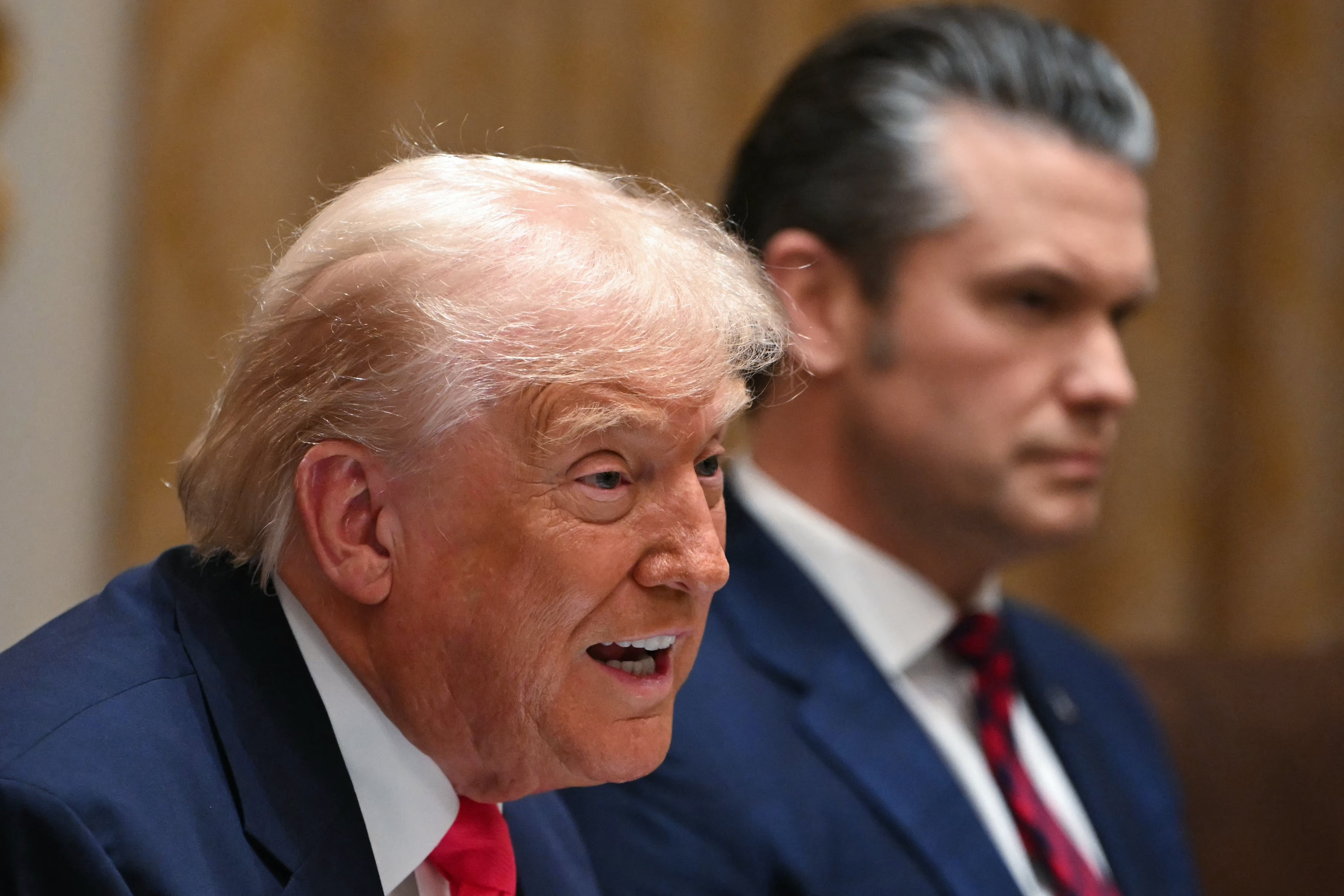 (L/R) US President Donald Trump speaks alongside Secretary of Defense Pete Hegseth during a Cabinet Meeting in the Cabinet Room of the White House in Washington, DC on December 2, 2025