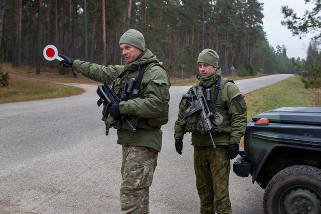 <p>Lithuanian soldiers patrol a road near the Lithuania-Belarus border near the village of Jaskonys, Druskininkai district some 160 km (100 miles) south of the capital Vilnius, Lithuania</p>
