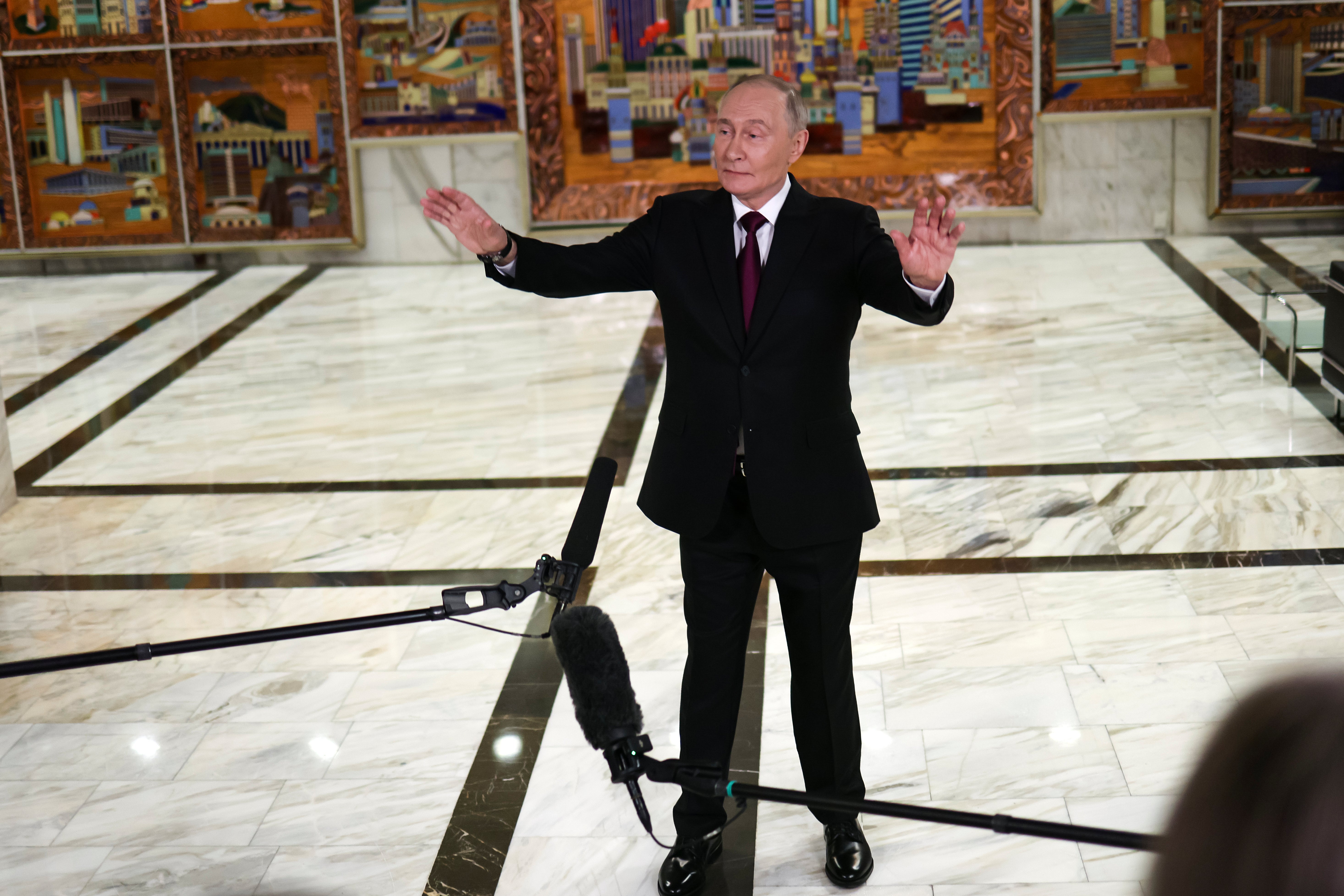 Russian president Vladimir Putin gestures speaking to journalists after the plenary session of the VTB "Russia Calling" Investment forum in Moscow