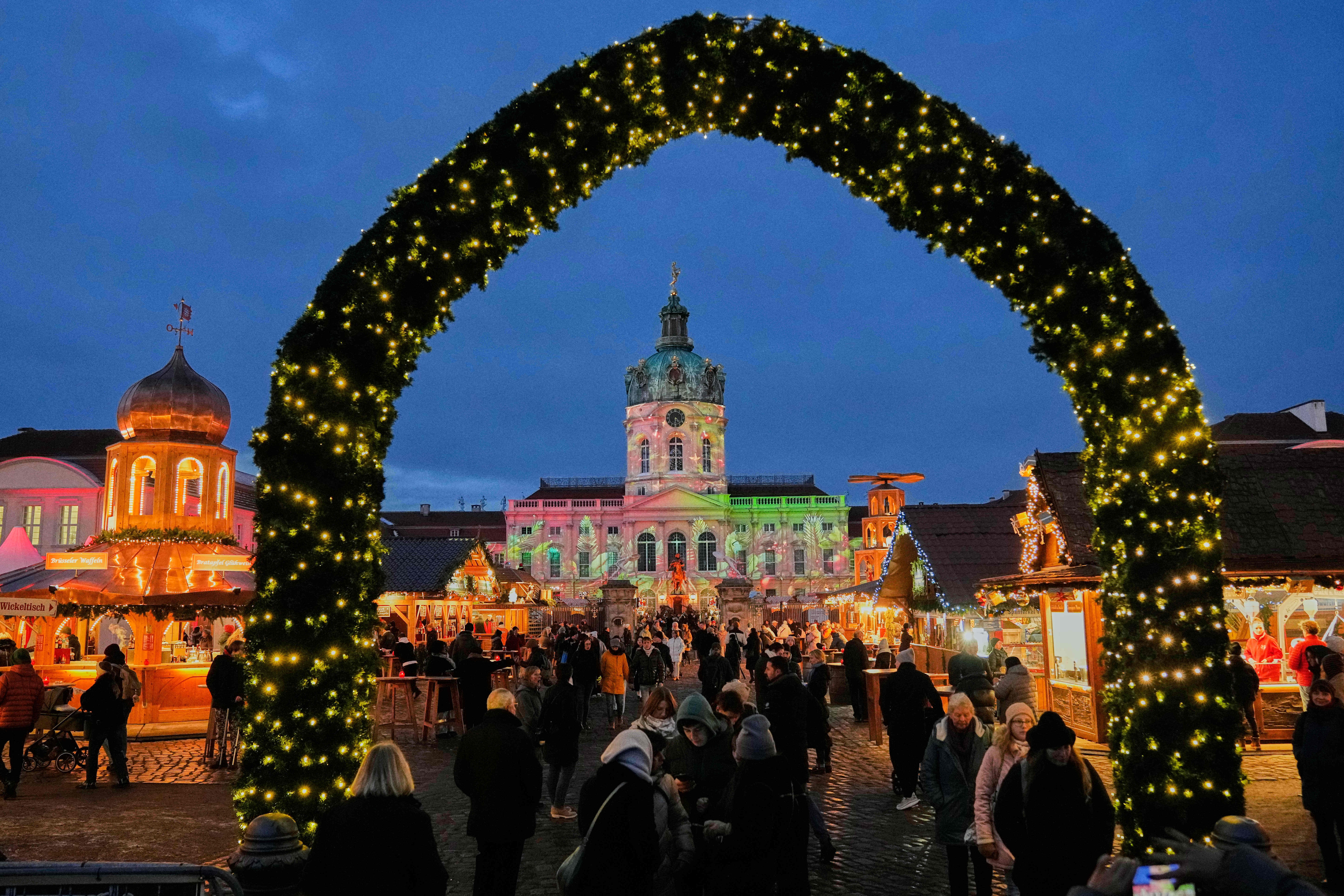 <p>People visit a Christmas Market at the Charlottenburg Palace in Berlin</p>