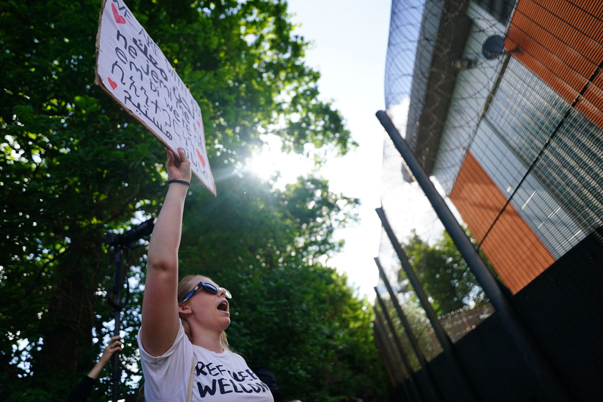 <p>Demonstrators at Brook House Immigration Removal Centre at Gatwick protest against plans to send migrants to Rwanda in June 2022</p>