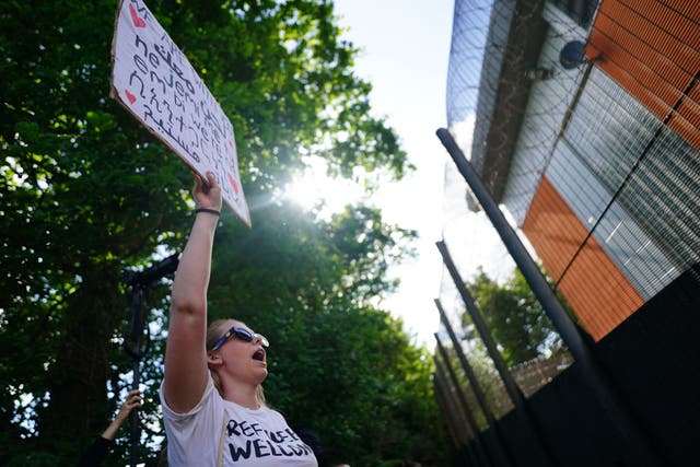 <p>Demonstrators at Brook House Immigration Removal Centre at Gatwick protest against plans to send migrants to Rwanda in June 2022</p>