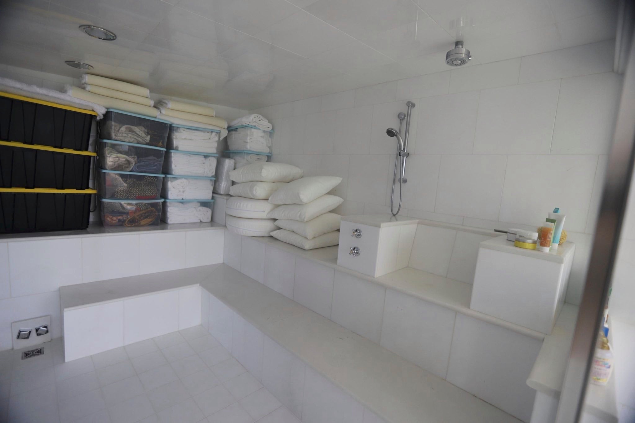 A photo taken of Epstein's estate depicts what seems to be a shower room with bins of extra towels and linens