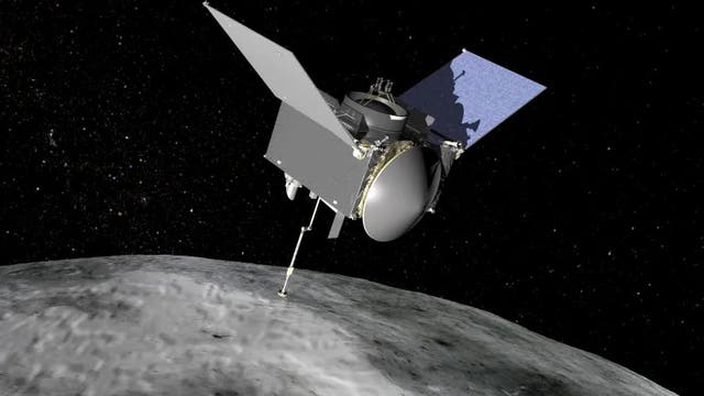 <p>An illustration shows the OSIRIS-REx spacecraft moving over the asteroid Bennu. NASA scientists have made some exciting discoveries using samples from the asteroid</p>