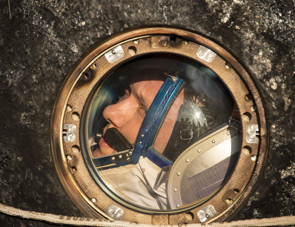 Oleg Artemyev looks out of the window of the Soyuz capsule just minutes after landing in a Soyuz TMA-12M capsule on 11 September, 2014 in Zhezkazgan, Kazakhstan