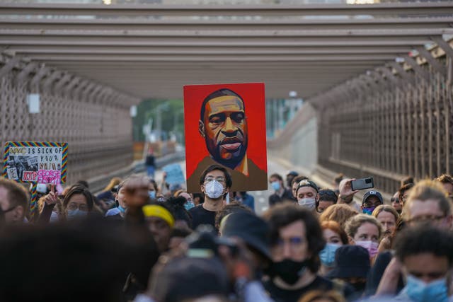 <p>Protesters gather while holding signs, including a portrait of George Floyd. His murder sparked protests nationwide, with demonstrators advocating for racial justice and police reform. Now, the cop who killed him is asking for a new trial. </p>