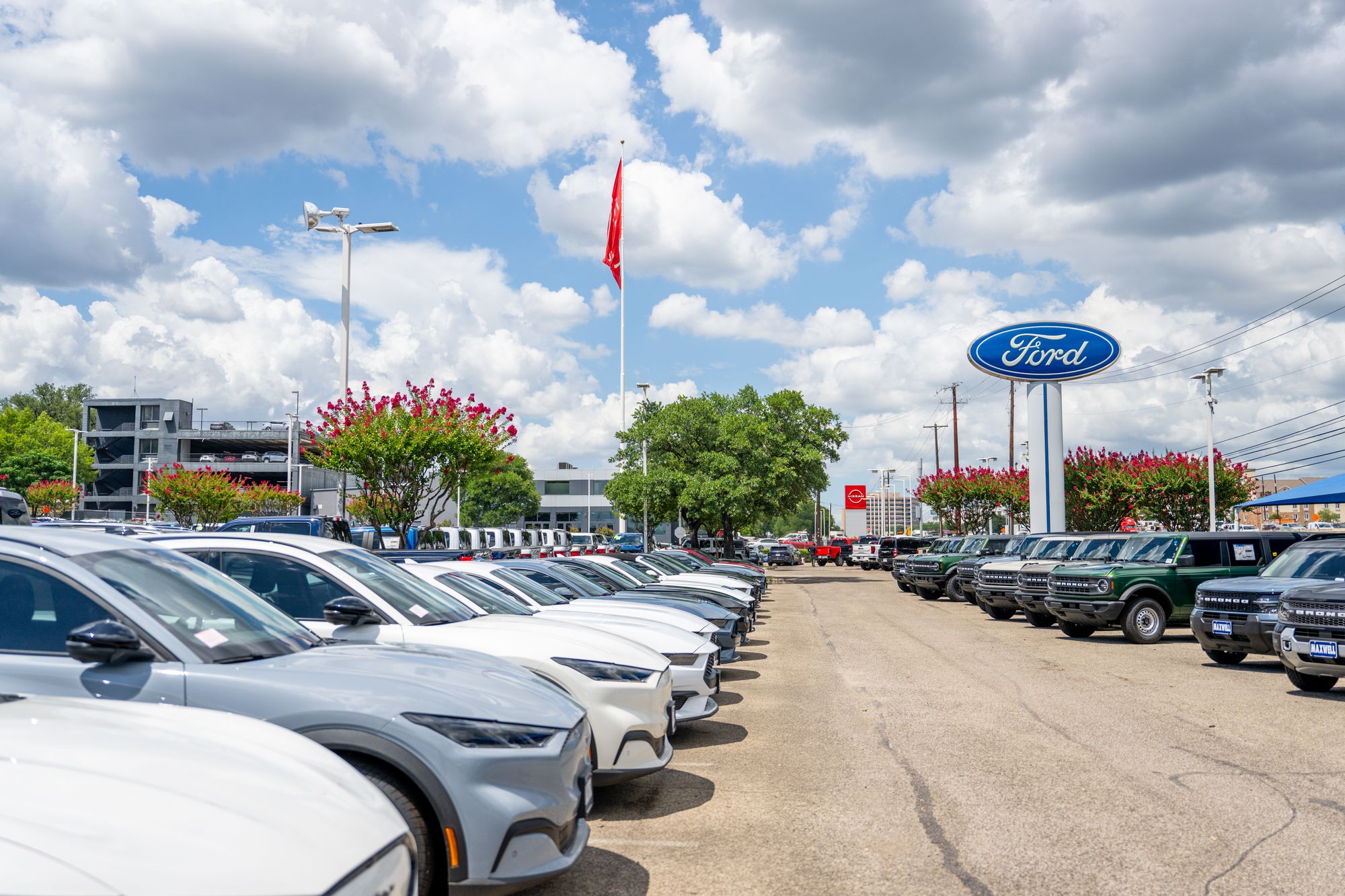 <p>Ford Mustang Mach-E vehicles are seen for sale on a dealership lot on June 24, 2025 in Austin, Texas</p>