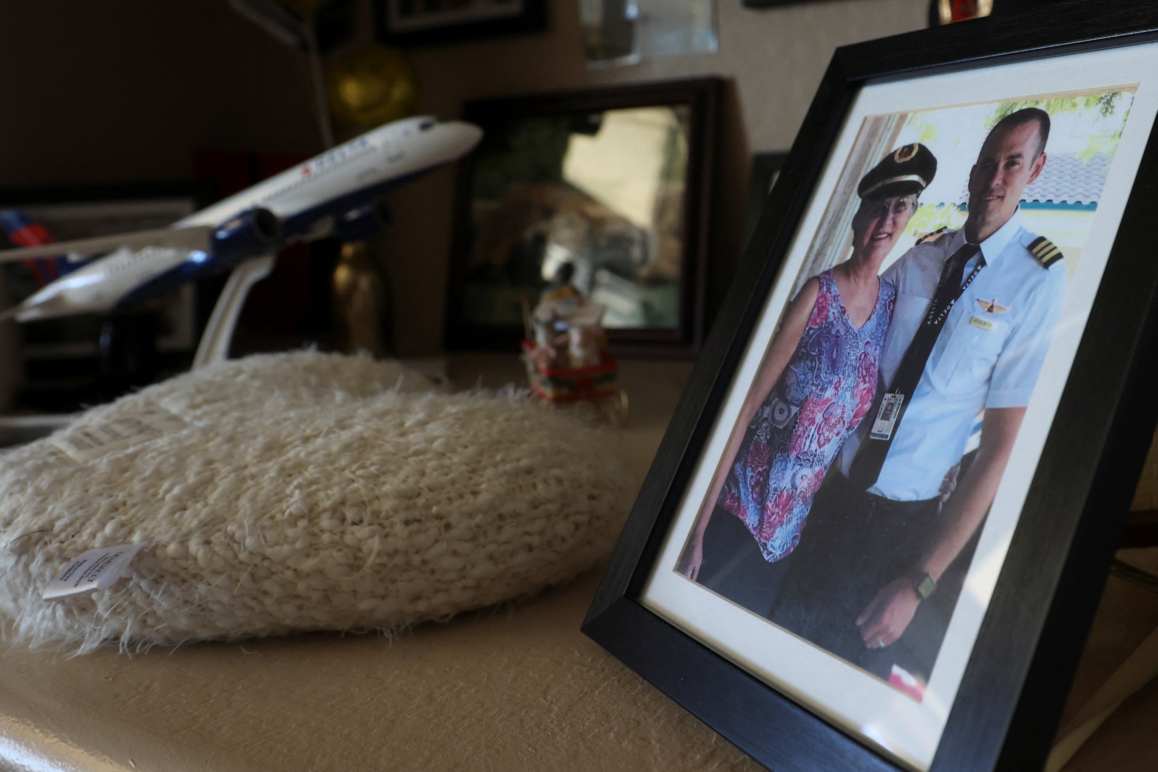 A framed photo of pilot Brian Wittke and his mother Annie Vargas stands on a memorial shelf at Vargas's home in Glendale, Arizona