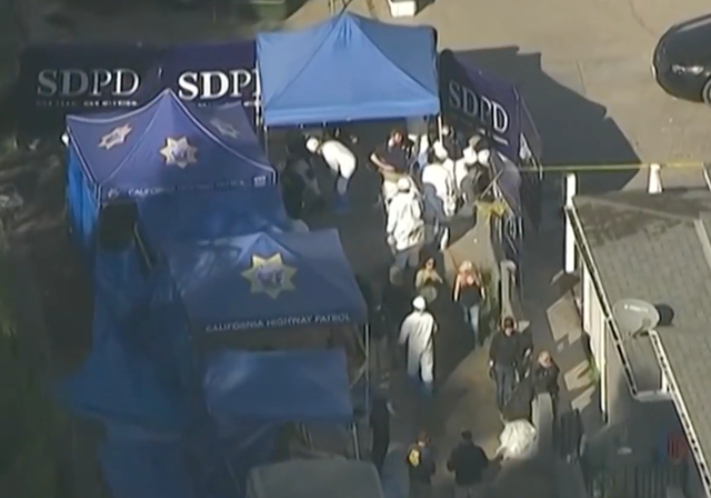 <p>Investigators at the house in the Southcrest neighborhood of San Diego, California, where the human remains were discovered</p>