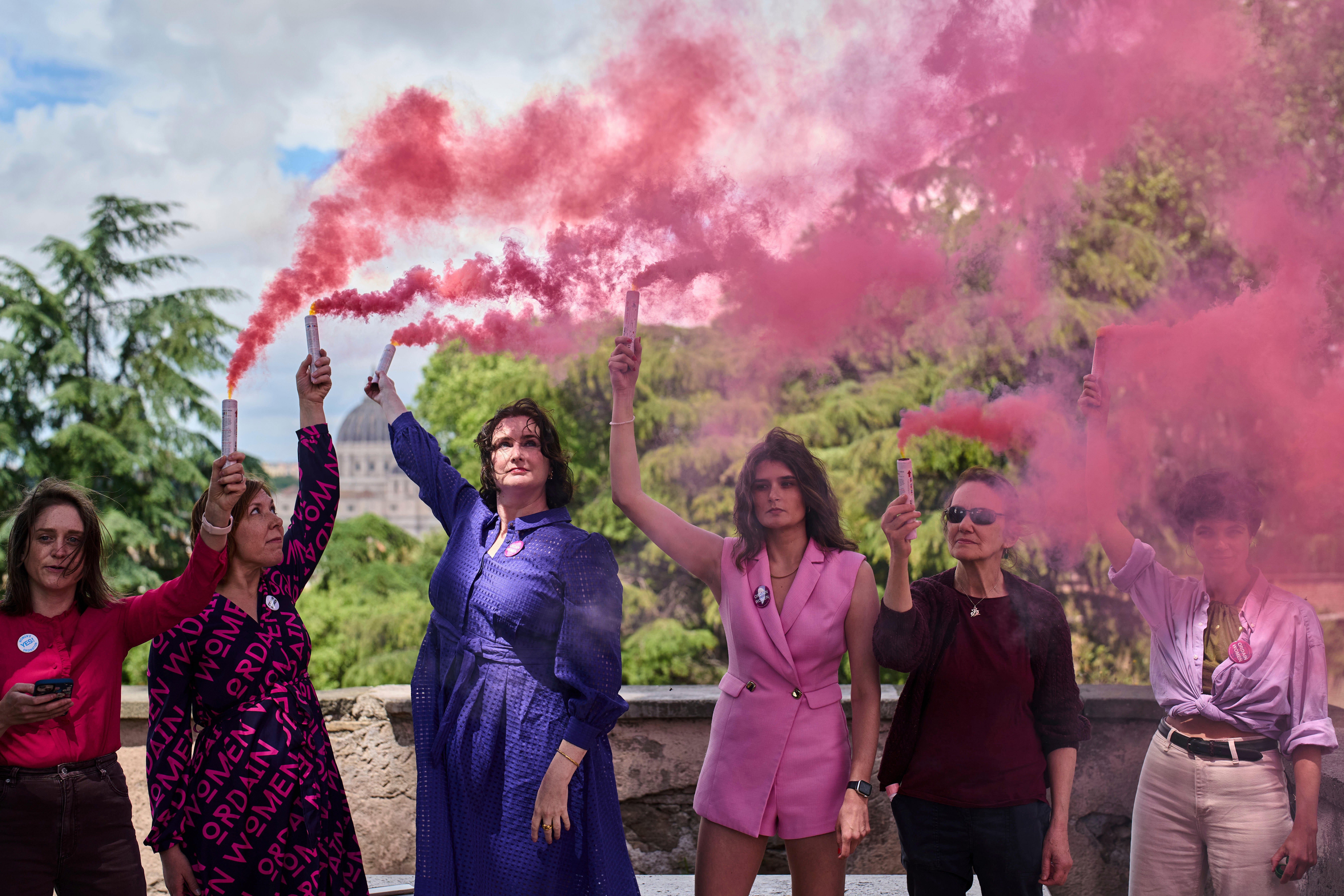 Activists from the Women's Ordination Conference release pink smoke to call for full equality for women in the Catholic Church on the first day of the conclave to elect the 267th pope, in Rome