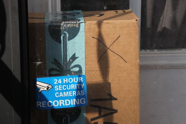 <p>Baltimore resident Rosemarie Dumhart uses a decoy package, marked with an X, to discourage the so-called 'porch pirates' operating in the Canton area of Baltimore, Maryland</p>