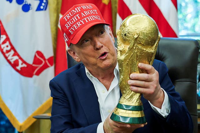 <p>President Donald Trump holding a FIFA World Cup trophy. The Trump administration refused to comment on whether or not immigration agents would target foreign fans attending the 2026 World Cup in the U.S. </p>