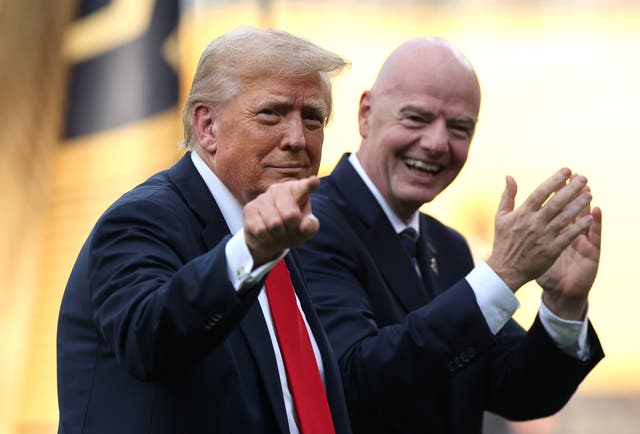 <p>President Donald Trump gestures as Gianni Infantino, president of FIFA, applauds following the FIFA Club World Cup 2025 Final match between Chelsea FC and Paris Saint-Germain at MetLife Stadium on July 13, 2025 in East Rutherford, New Jersey</p>