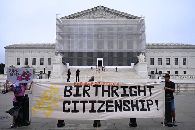 <p>Demonstrators holds up an anti-Trump sign outside the US Supreme Court in Washington, DC, on June 27, 2025</p>