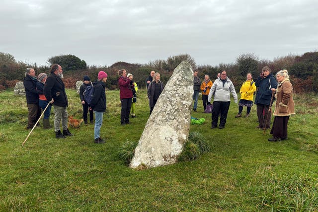 <p>Residents of Cornwall, England, visit the Boscawen-Ûn stone circle near Penzance, Nov. 5, 2025. Carolyn Kennett, center in white jacket, led the guided walk. (Yonat Shimron/Religion News Service via AP)</p>