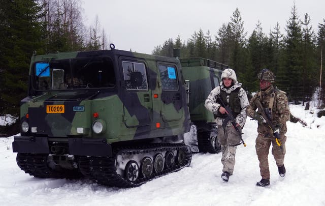 <p>Jaeger Aapo Peltokongas from the Finnish army and Lance Corporal Aidan Rickards from 3 rifles in Vusoanka near Kajaani (Owen Humphreys/PA)</p>