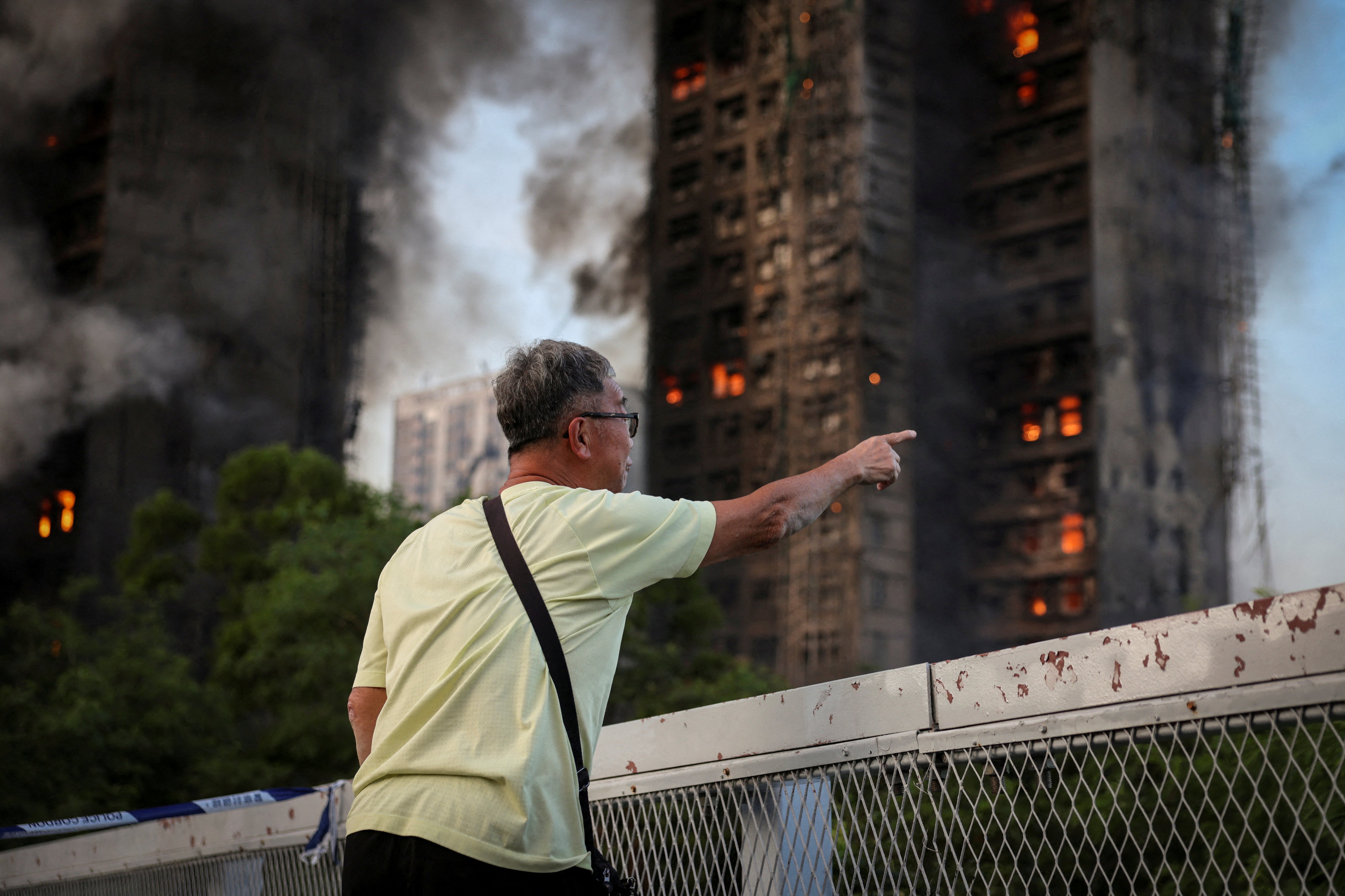 A distraught resident says his wife is trapped inside Wang Fuk Court during a major fire, in Tai Po, Hong Kong