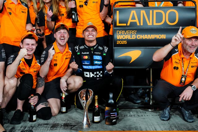 Lando Norris celebrates winning the world championship with McLaren staff (David Davies/PA)
