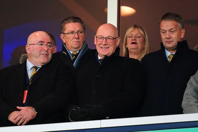 John Swinney, centre, has said the Scottish Government will work with councils to relax pub opening hours for the World Cup (Jane Barlow/PA)