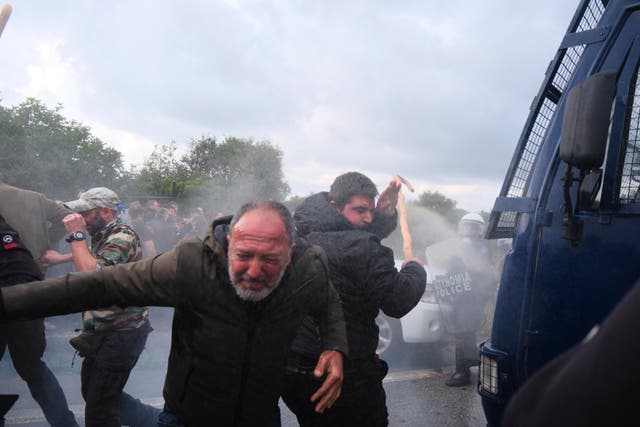 <p>Police use tear gas against farmers during clashes with officers blocking their march to Chania's airport on Crete, Greece</p>