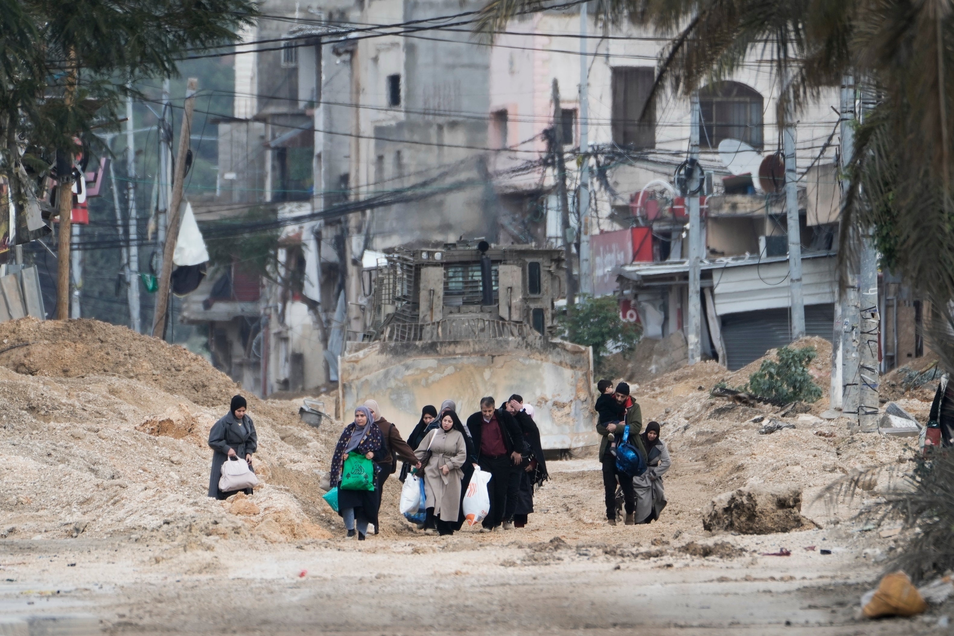 <p>Residents of the West Bank refugee camp of Nur Shams, Tulkarem, evacuate their homes as the Israeli military continues its operation in the area on Feb. 11, 2025. (AP Photo/Majdi Mohammed, File)</p>
