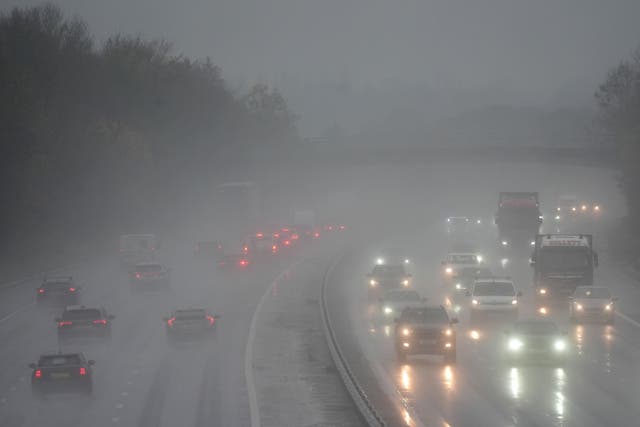 Motorists travel through rain and spray on the M11 near Harlow in Essex (Joe Giddens/PA)
