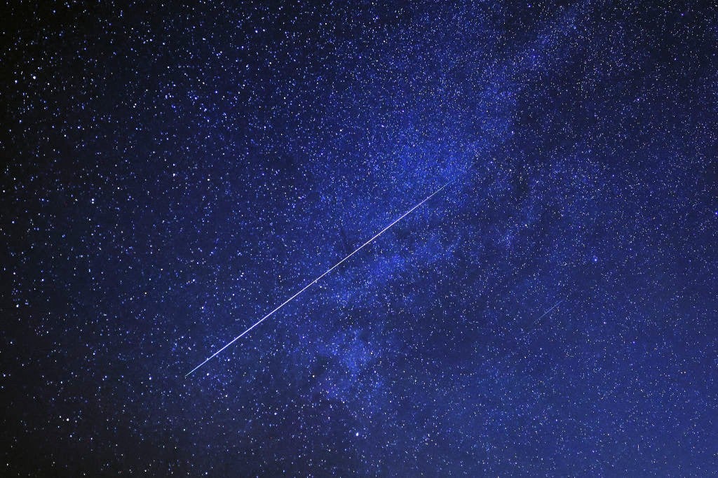 A meteor burns up in the sky over al-Abrak desert north of Kuwait City during the annual Geminid meteor shower early on 15 December, 2023