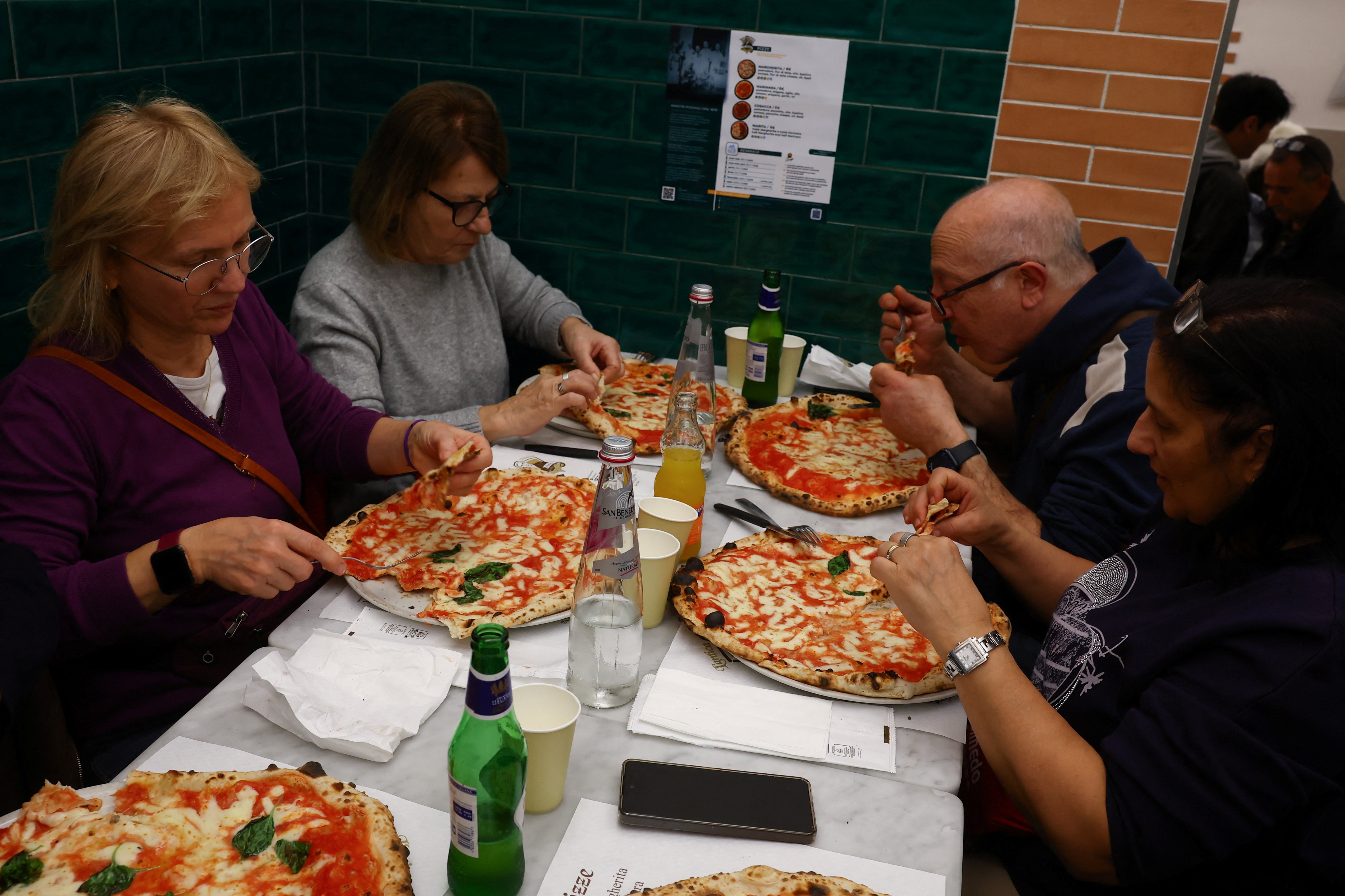People eat pizzas at L'antica Pizzeria da Michele