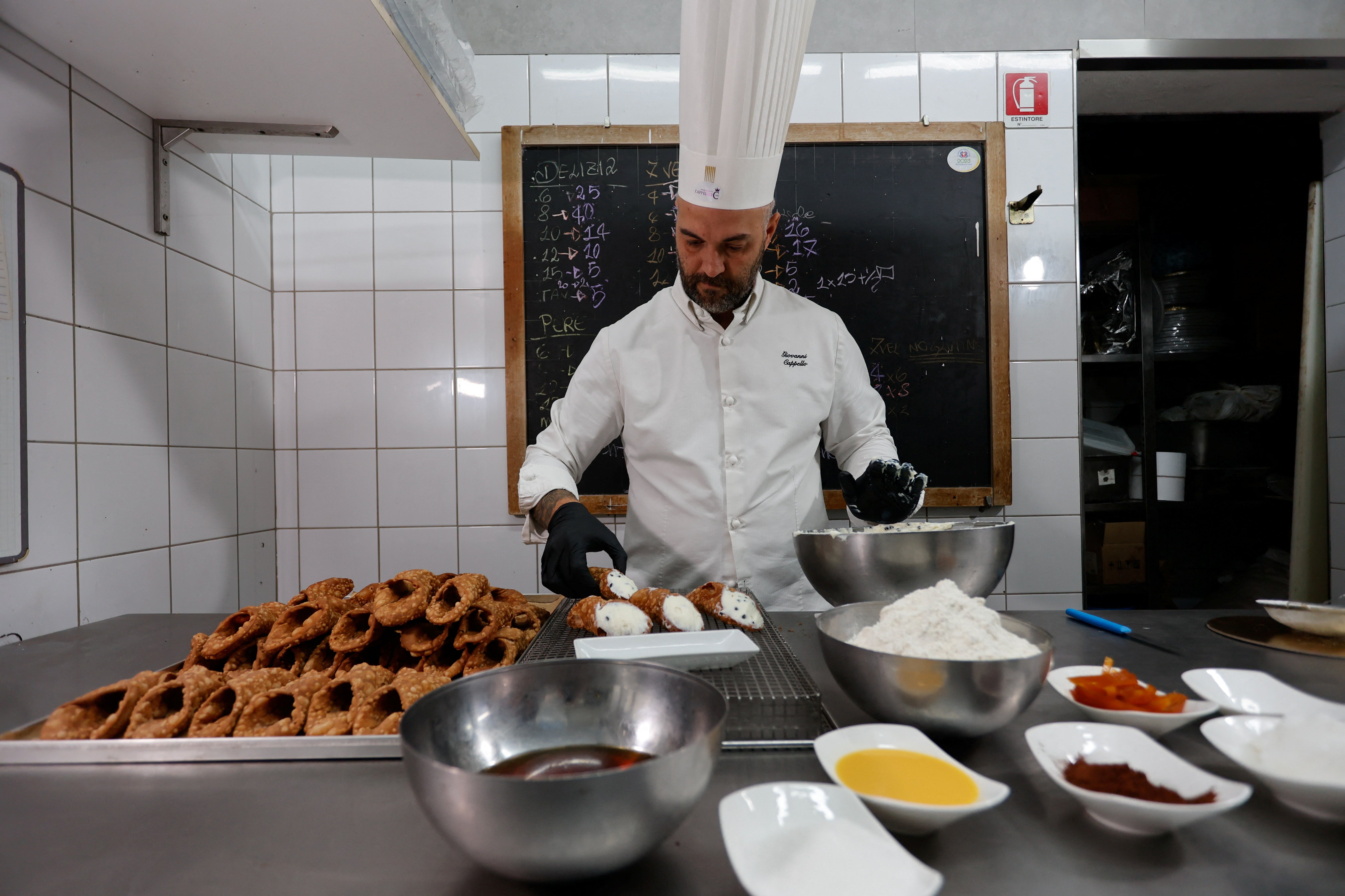 Pastry chef Giovanni Cappello prepares Sicilian cannoli at Pasticceria Cappello