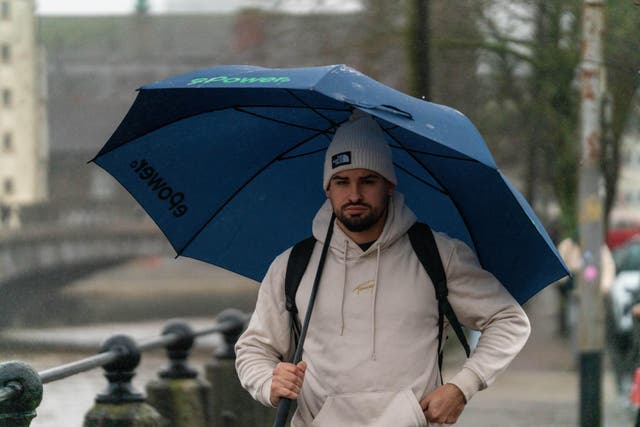 People shelter from the rain in Cork amid Storm Bram (Noel Sweeney/PA)