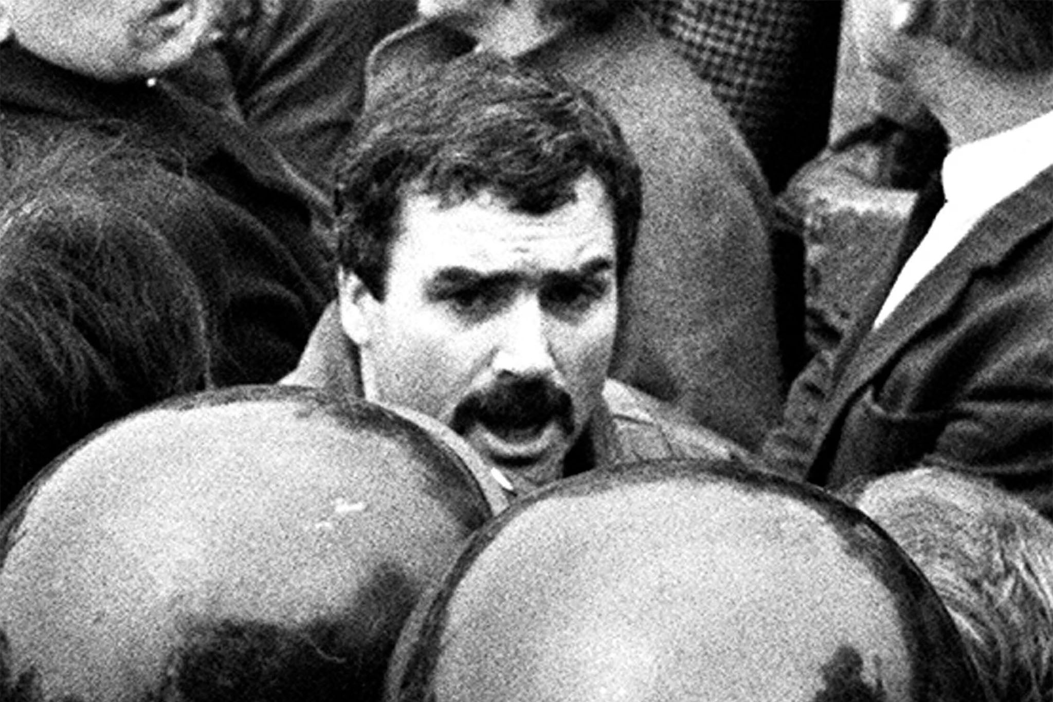 <p>Stakeknife is believed to be west Belfast man Freddie Scappaticci, pictured at an IRA funeral in 1987. The agent ‘committed grotesque, serious crime’, according to an investigation into his activities</p>