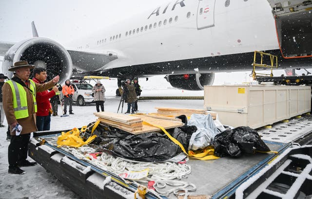 <p>Representatives from various First Nations look on as a kayak and other indigenous artefacts arrive at Trudeau Airport in Montreal</p>