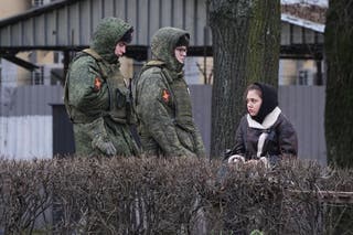 Soldiers patrol an area around an office for recruitment for contract service in the Russian armed forces in St Petersburg, Russia