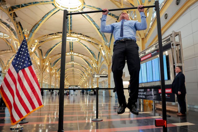 <p>Human Services Secretary Robert F. Kennedy Jr. does pull-ups after a conference discussing the launch of the "Make Travel Family Friendly Again" campaign at Ronald Reagan Washington National Airport</p>
