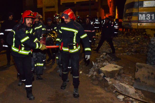 <p>Rescue workers at the wreckage of two collapsed buildings in Fez</p>