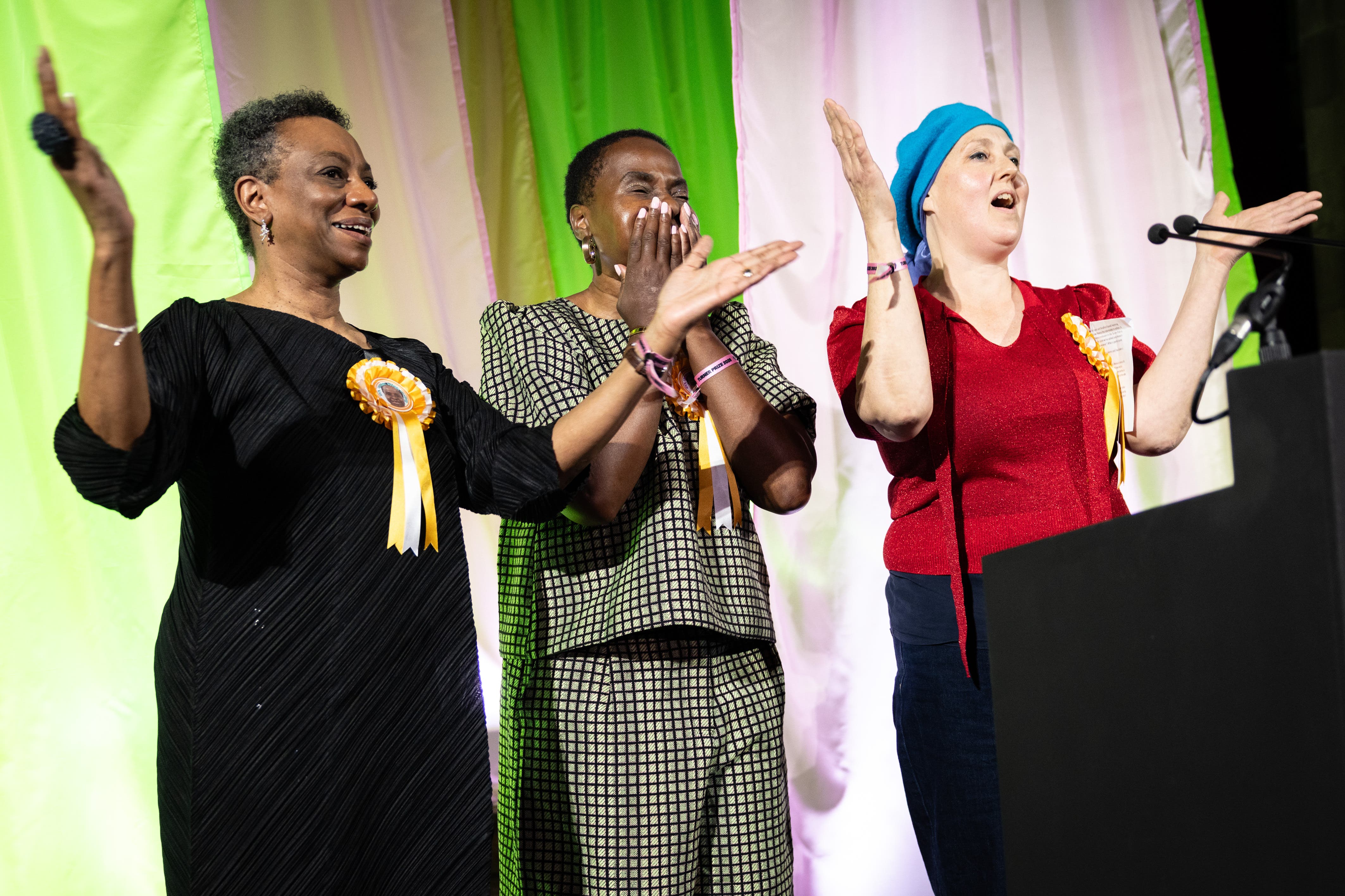 <p>Nnena Kalu (centre) is announced as the winner of the Turner Prize 2025 (James Speakman/PA)</p>