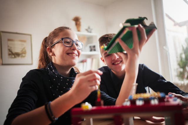 <p>Teenagers playing with Legos</p>