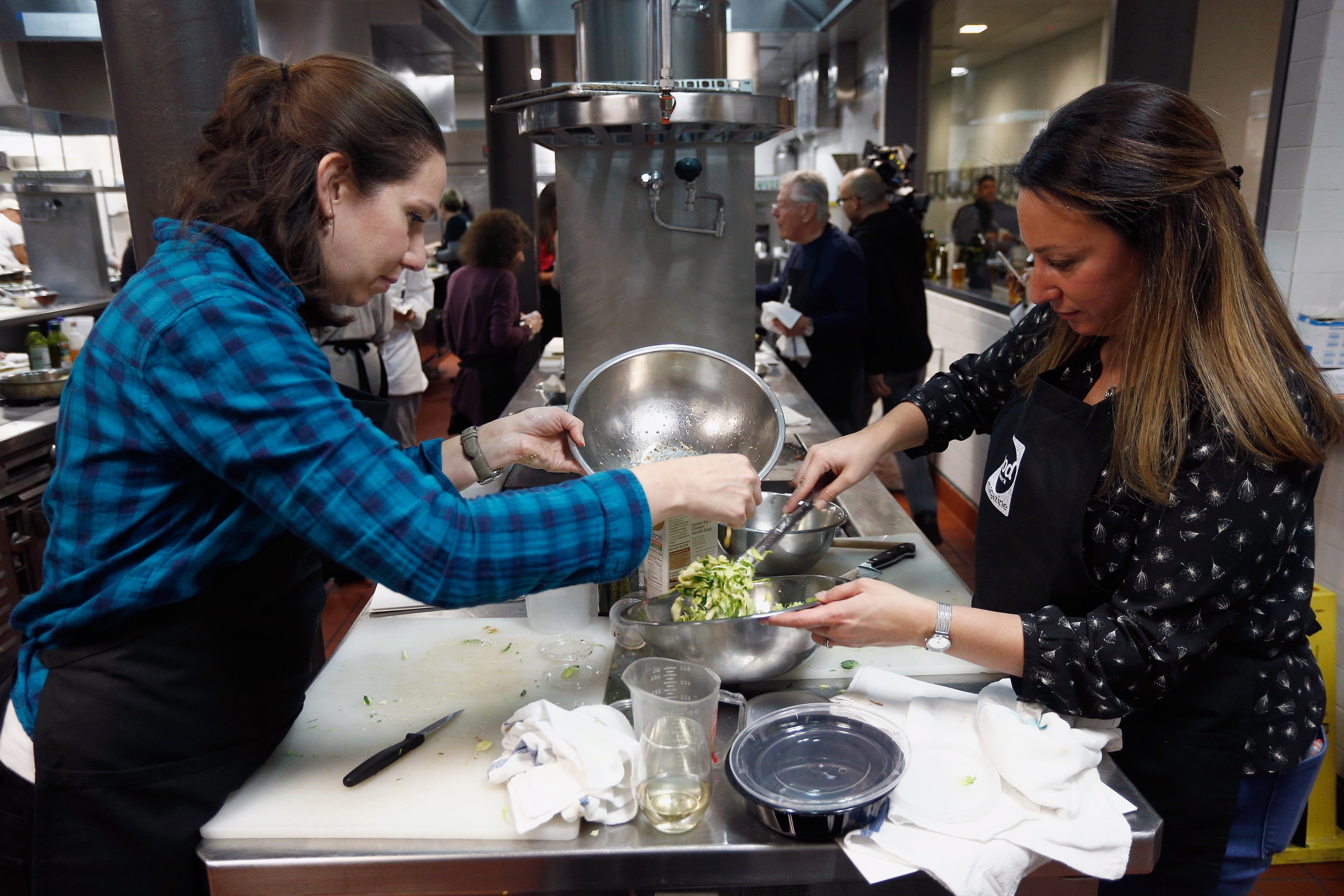 <p>Women prepare a dish in New York City in November 2017. Brussels sprouts are packed with fiber and other nutrients beneficial for your health</p>