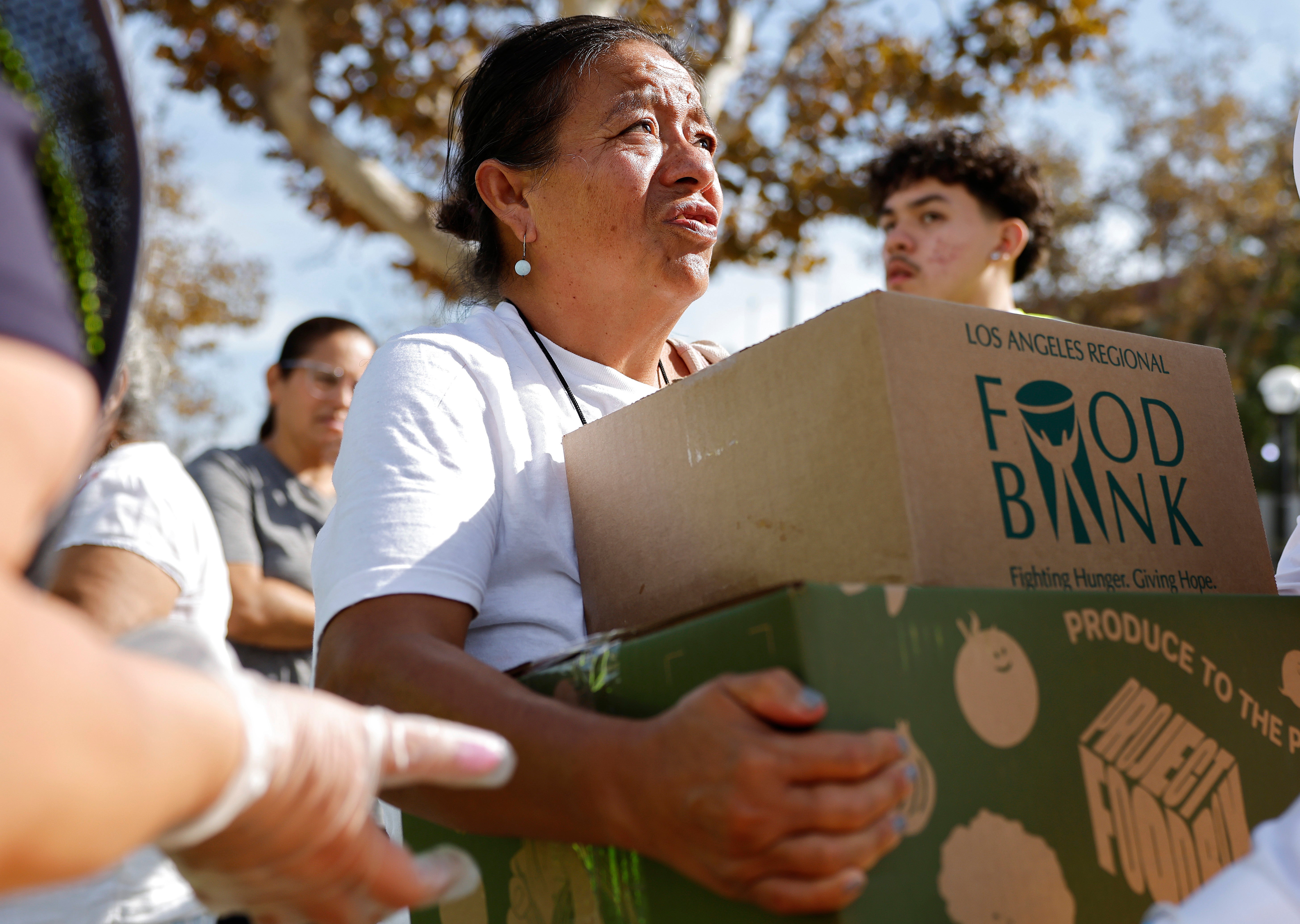 People receive free food boxes at a large-scale food distribution, in response to the federal government shutdown and SNAP/CalFresh food benefits delays, on November 11, in Los Angeles. Food banks across the country are seeing more people seeking assistance after threats to SNAP funds and new cuts to the program under President Donald Trump