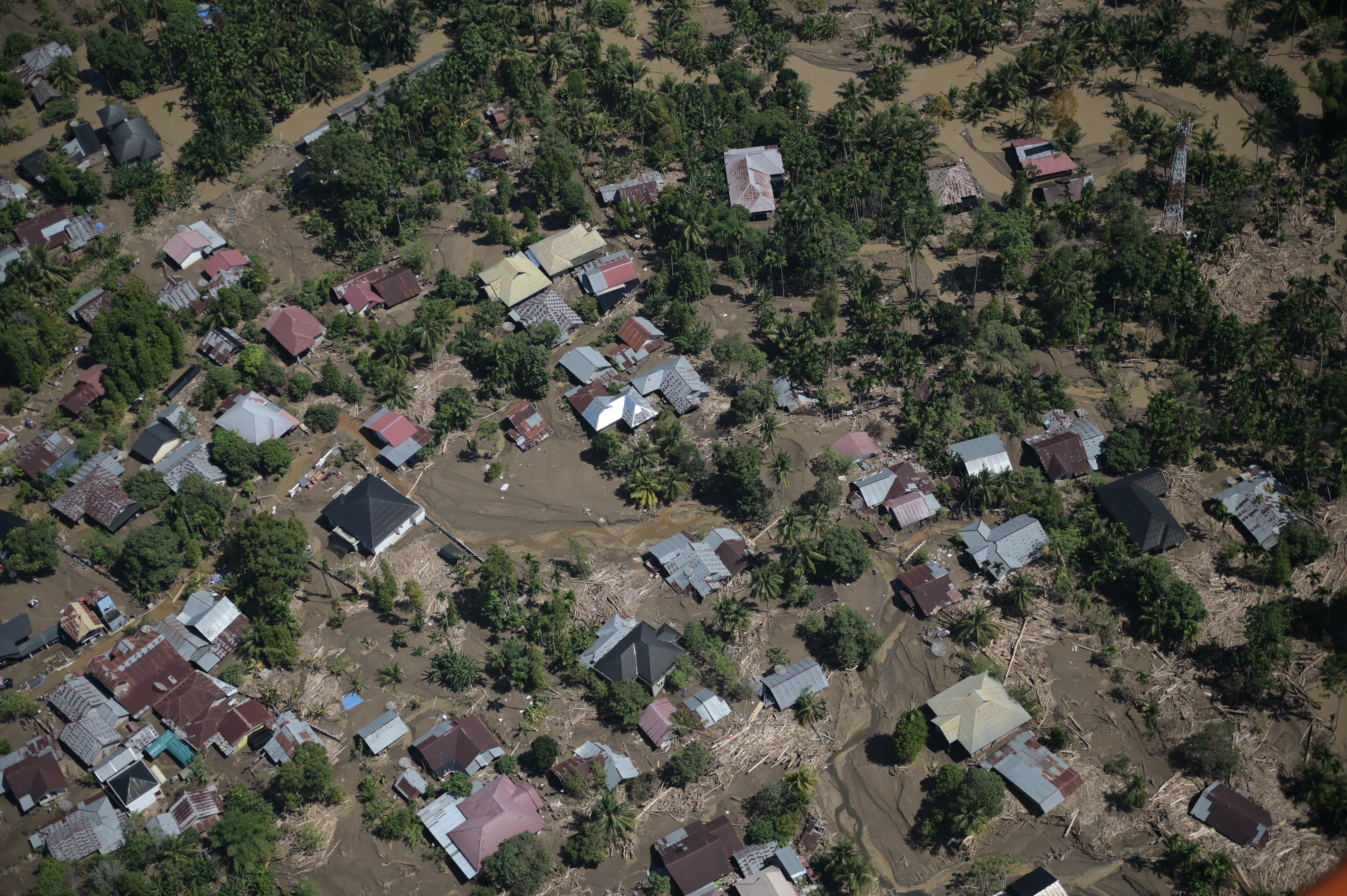 This photo taken from a national disaster mitigation agency's helicopter during an aerial aid distribution shows an area affected by floods in the aftermath of Cyclone Senyar in Pidie Jaya, Aceh province, Indonesia,