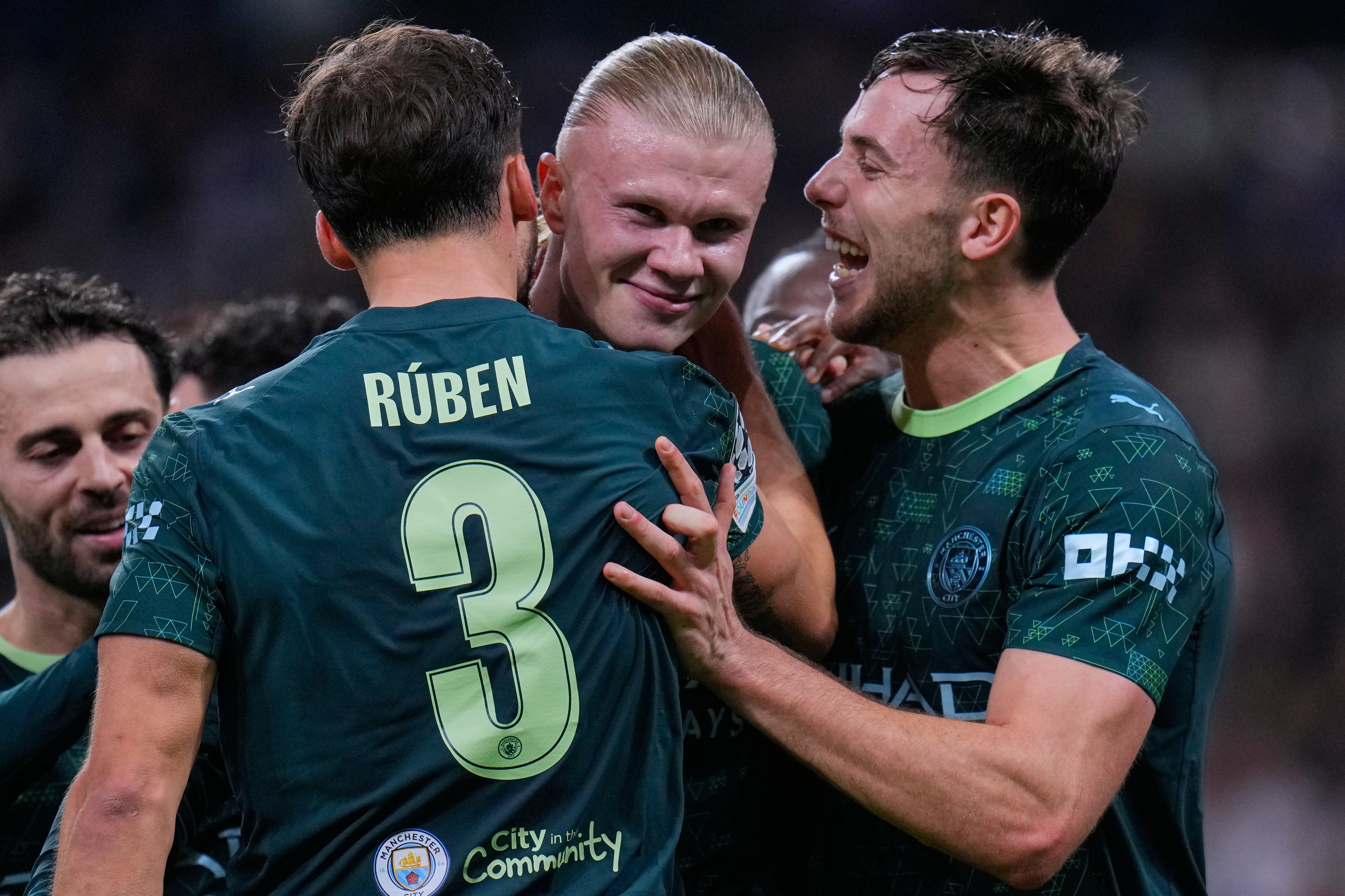 <p>Erling Haaland celebrates with teammates after scoring their side's second goal during a Champions League opening phase soccer match between Real Madrid and Manchester City</p>