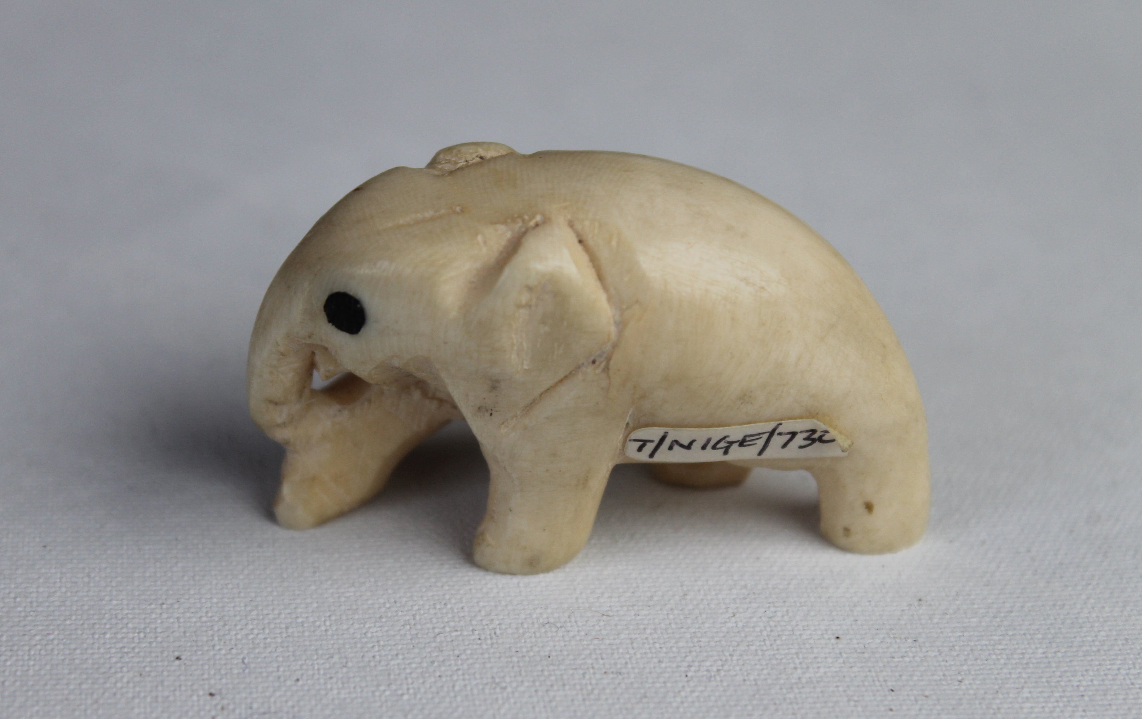 An elephant ornament, carved ivory, inlaid ebony eyes, one of more than 600 artefacts that were stolen
