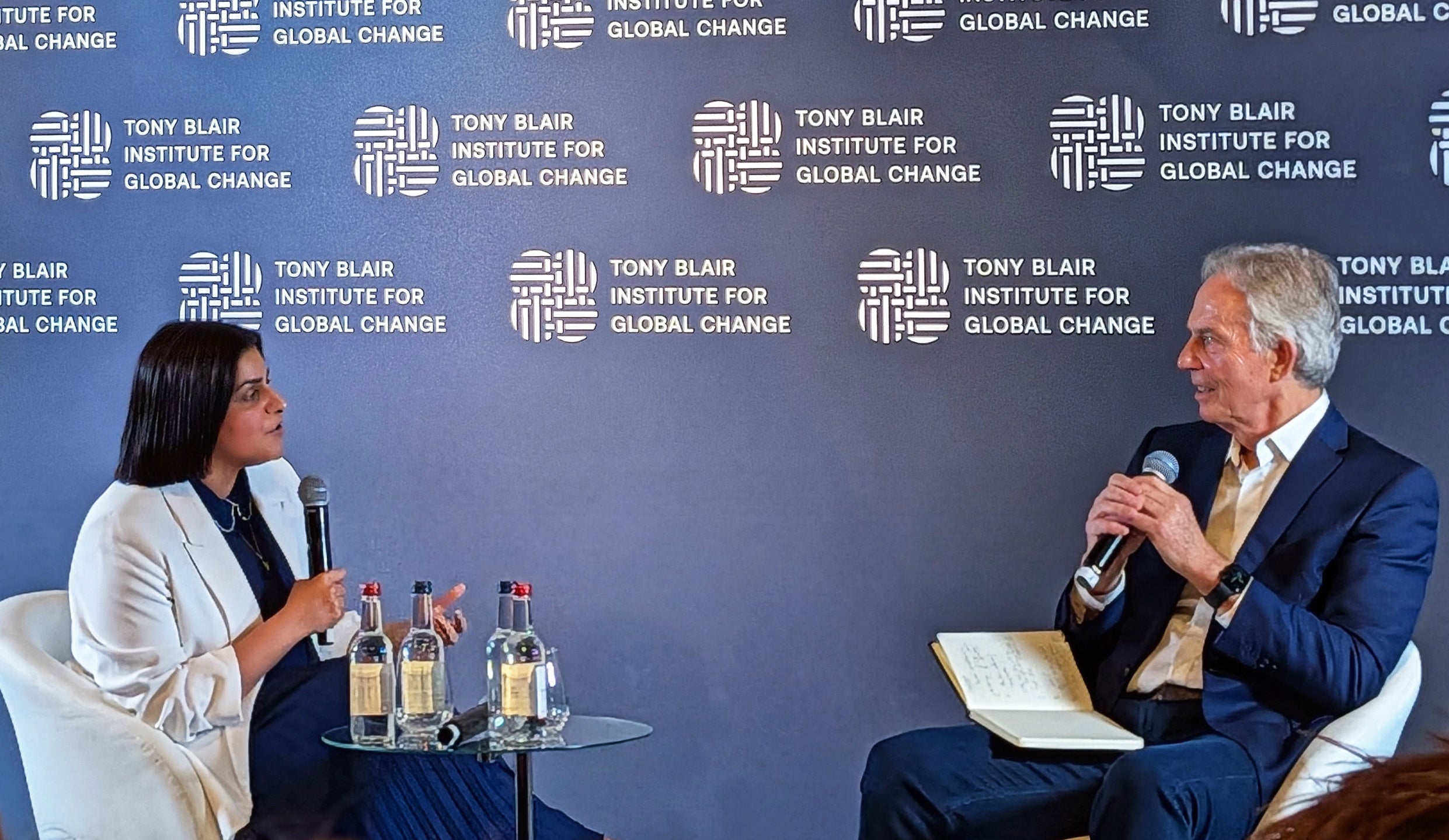 Tony Blair interviews Shabana Mahmood on stage at the TBI Christmas party