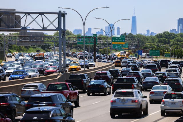 <p>Vehicles drive along a highway ahead of Memorial weekend in Queens, New York city on May 24, 2024</p>