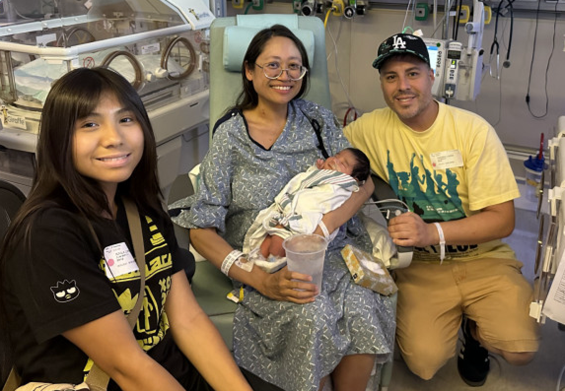 <p>The Lopez family with their newborn son, Ryu. Suze Lopez discovered she was pregnant with Ryu after going in for a surgery to have a 22-pound ovarian cyst removed</p>