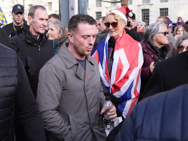 <p>Tommy Robinson (centre) during a Christmas carol service in Whitehall, London organised by his Unite the Kingdom movement.</p>